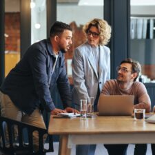 Employees collaborating and designing an intranet | Intranet vs. digital workplace